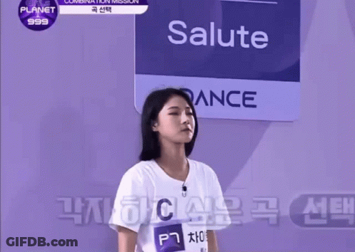 Girl In White Shirt In Front Of Salute Sign GIF