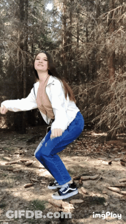 Girl In White Sweater Jumping For Joy GIF