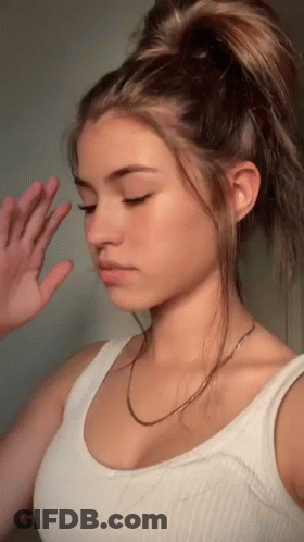 Girl In White Tank Top With Hand On Face GIF