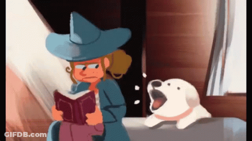 Girl In Witch Hat Reading Book Next To Dog GIF