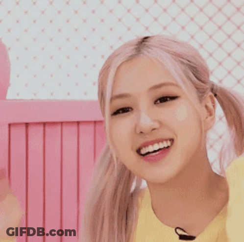 Girl In Yellow Sweater Smiling With Pigtails GIF