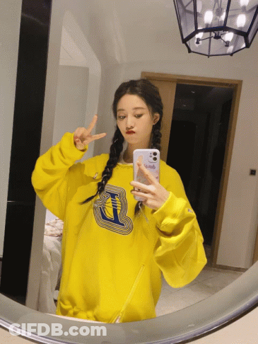 Girl In Yellow Sweatshirt Taking Selfie GIF