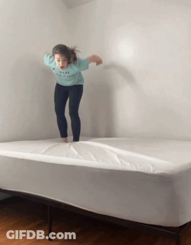 Girl Jumping On Bed With Push Shirt GIF