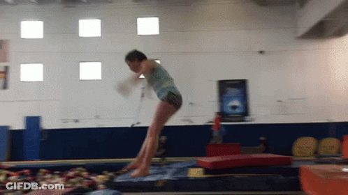 Girl Jumping On Trampoline In Gym GIF