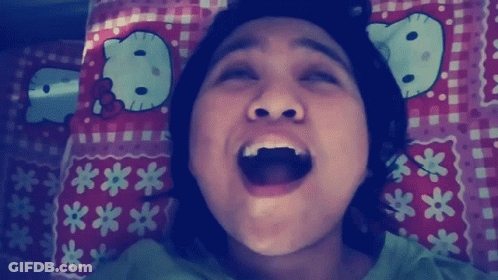 Girl Laying On Bed With Hello Kitty Pillow GIF