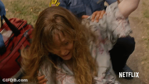 Girl Laying On Ground With Netflix Logo GIF