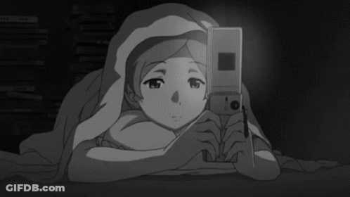 Girl Laying Under Blanket Looking At Cell Phone GIF