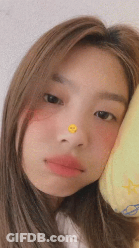 Girl Looking At Camera With Smiley Face On Nose GIF