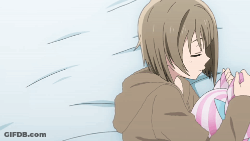 Girl Lying On Bed Holding Pink And Blue Pillow GIF