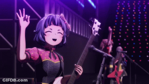 Girl Playing Guitar And Singing Into Microphone On Stage GIF