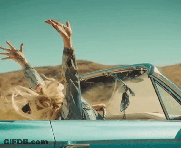 Girl Raising Hands On Road Trip GIF