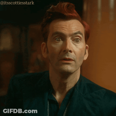 Girl Reading Book At Desk Next To Girl With Purple Hair GIF