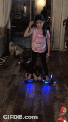 Girl Riding Hoverboard In Living Room GIF