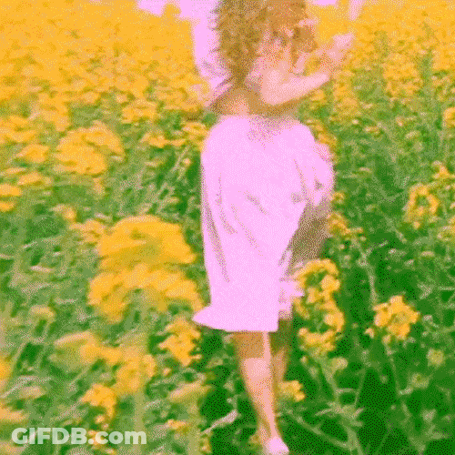 Girl Running In The Garden Of Flowers GIF