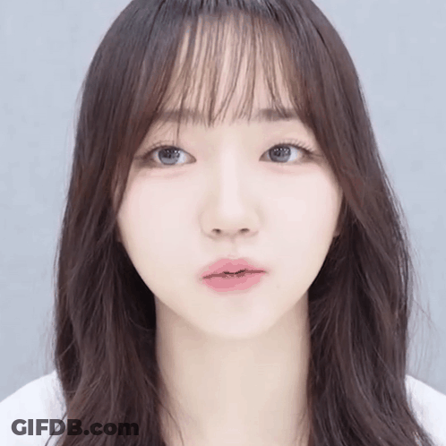 Girl's Face Close Up With Long Hair And Bangs GIF