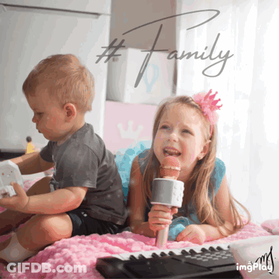 Girl Singing Into Mic Beside Boy Playing Toy Piano GIF