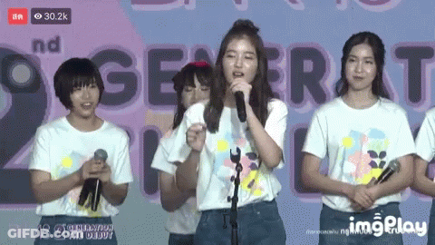 Girl Singing Into Microphone With 2Nd Generation Banner GIF