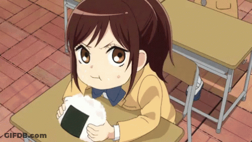 Girl Sitting At Desk Holding Rice Ball GIF