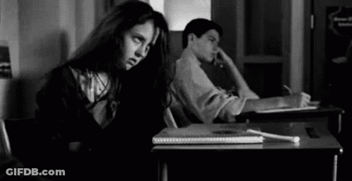 Girl Sitting At Desk Next To Boy GIF