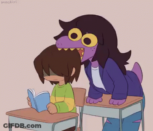 Girl Sitting At Desk Reading Book Next To Purple Hair Girl GIF