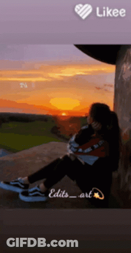 Girl Sitting At Sunset With Like Button Above GIF