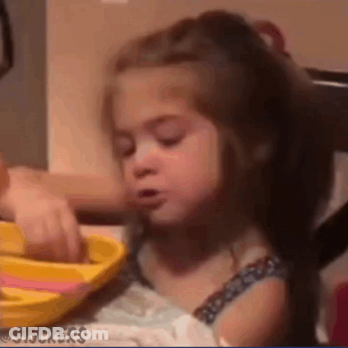 Girl Sitting At Table With Yellow Plate GIF