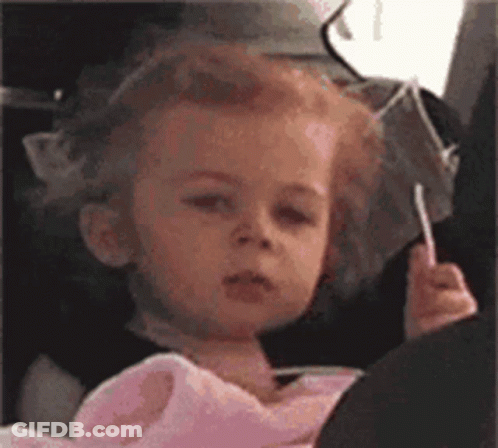 Girl Sitting In Car Seat With Lollipop GIF