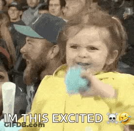 Girl Sitting In Crowd Eating Cotton Candy GIF