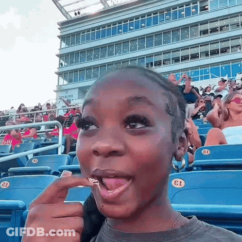 Girl Sitting In Stadium With Number 13 GIF
