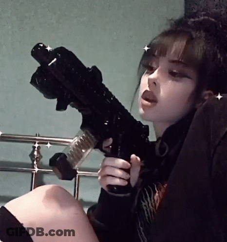 Girl Sitting On Bed Holding Black Gun GIF