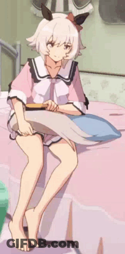 Girl Sitting On Bed With Pillow And Brush GIF