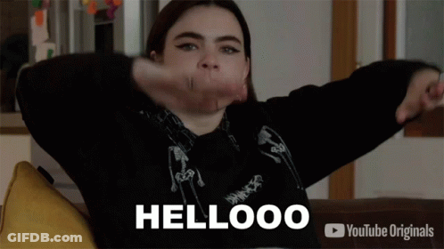 Girl Sitting On Couch Arms Outstretched Saying Hellooo GIF