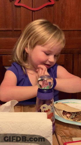 Girl Sitting With Snow Globe Bottle GIF