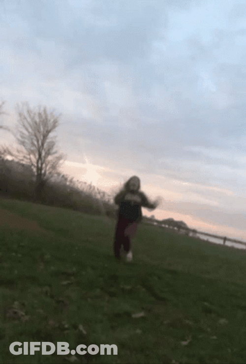 Girl Slipping On The Grass Field GIF