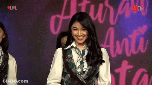 Girl Smiling At Sign Saying Live GIF
