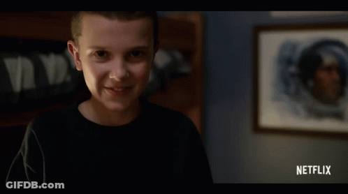 Girl Smiling In Front Of Netflix Ad GIF