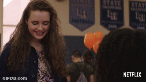 Girl Smiling In Front Of Netflix Banner GIF