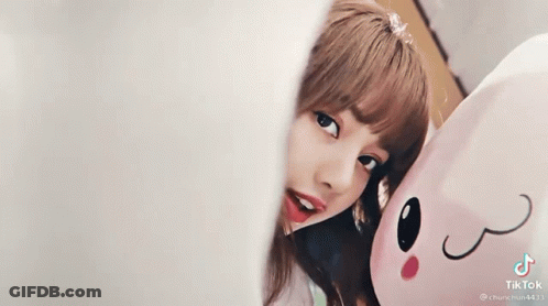 Girl Smiling Next To Stuffed Animal GIF