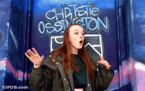 Girl Standing In Front Of Christie Ossington Wall GIF