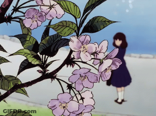 Girl Standing In Front Of Flowers GIF
