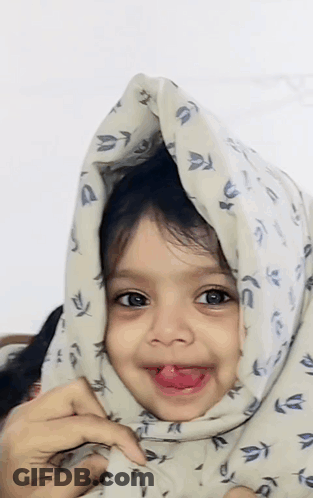 Girl Sticking Tongue Out With Blanket Over Head GIF