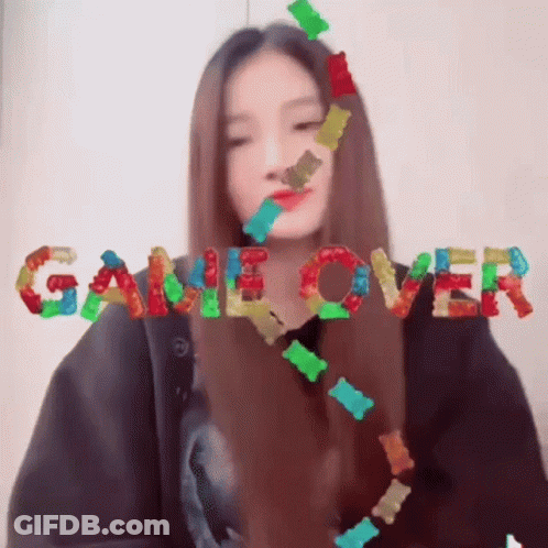 Girl Surrounded By Gummy Bears Saying Game Over GIF