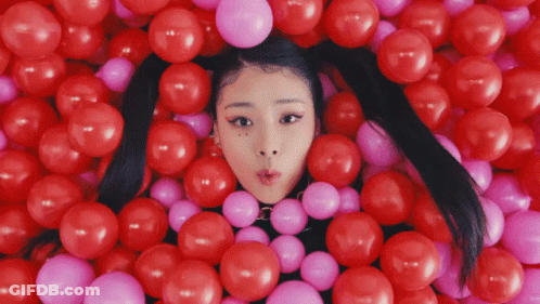 Girl Surrounded By Red And Pink Balloons GIF