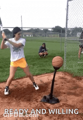 Girl Swinging Bat At Basketball On Tee Ball Stand GIF