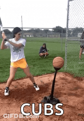 Girl Swinging Bat At Basketball On Tee While Another Watches GIF