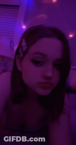 Girl Taking Selfie In Dark Room With Purple Lights GIF
