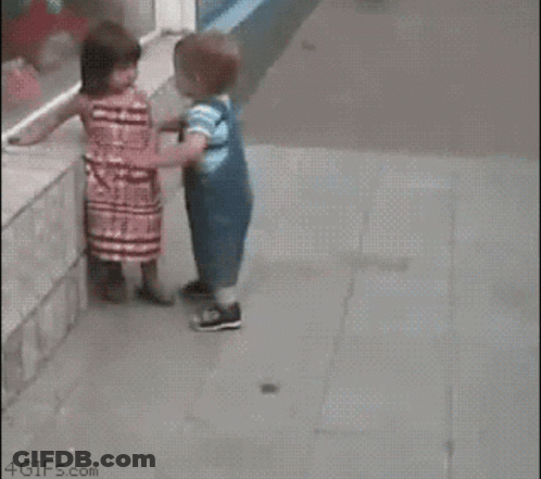 Girl Touching Boy's Face While Walking GIF