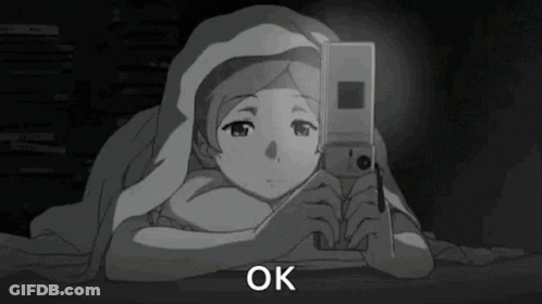 Girl Under Blanket Looking At Phone GIF