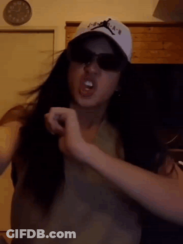 Girl Wearing Hat And Sunglasses Making Funny Face GIF