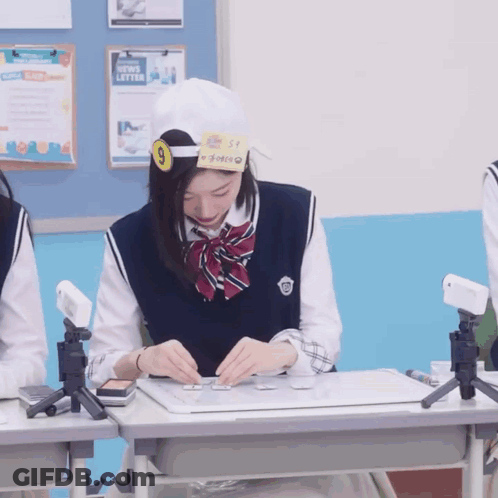 Girl Wearing Number 9 Sitting At Desk GIF